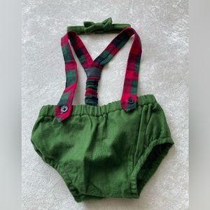 Green bloomers with plaid suspenders and matching green bow tie